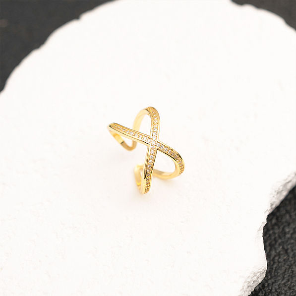 gold adjustable criss cross ring on white stone
