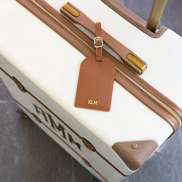 brown luggage tag on luggage