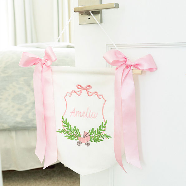 pink new baby banner on door