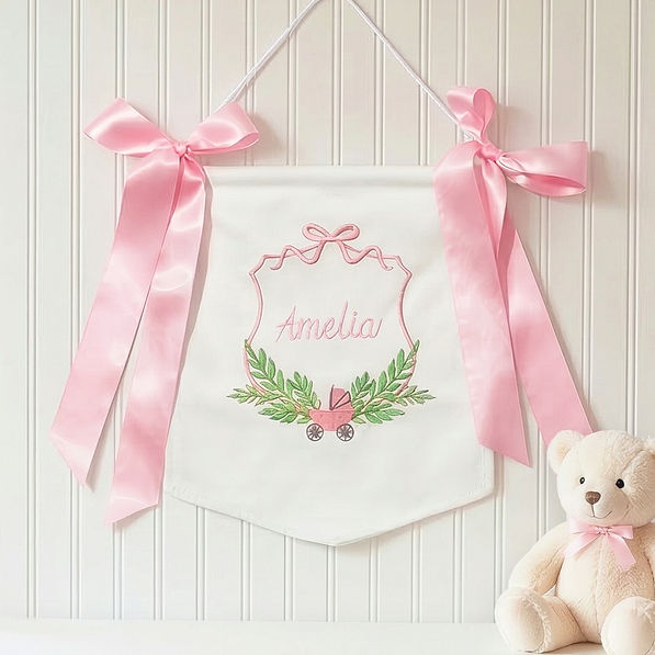pink new baby banner on wall