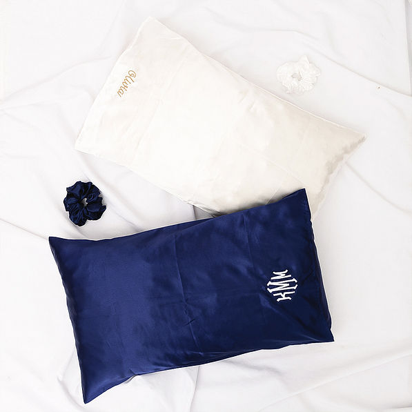 white and navy satin pillowcases and scrunchies on sheets