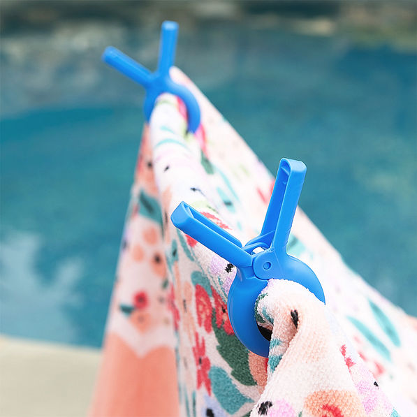 Blue beach chair towel clips with coral floral towel