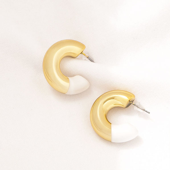 enamel hoop earrings on fabric