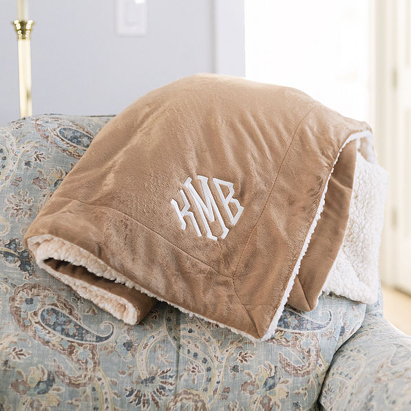 brown monogrammed sherpa blanket on chair