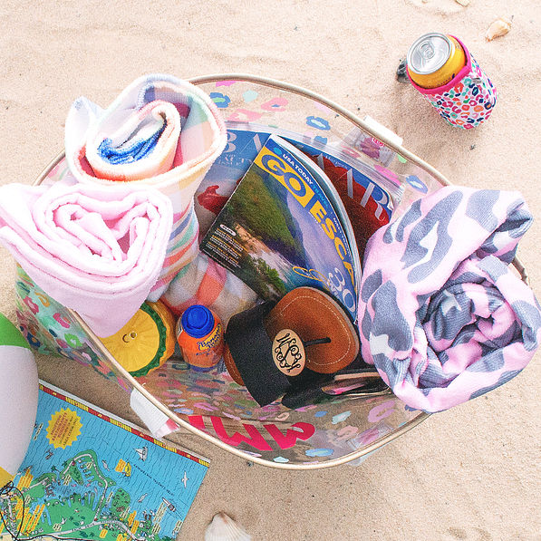 inside monogrammed clear beach bag in sand