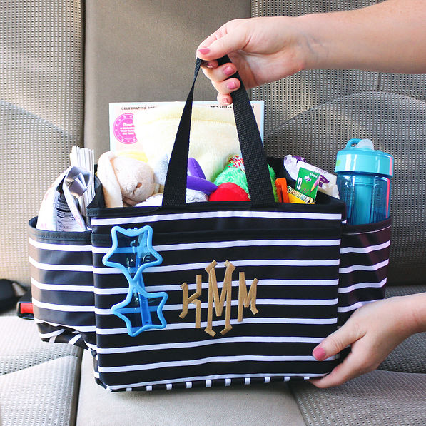 black and white monogrammed car seat organizer with kids toys