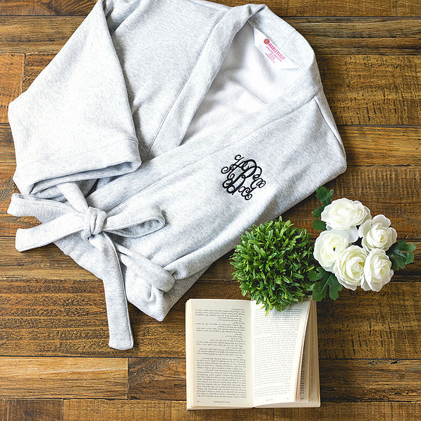 gray monogrammed robe with book