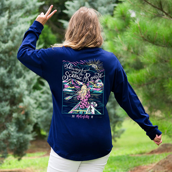 girl wearing scenic route tee shirt holding up peace sign