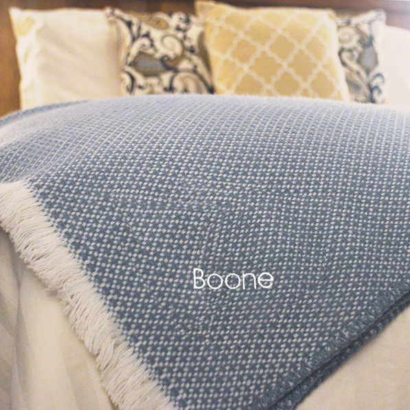 personalized with name woven  throw blanket on bed corner in slate blue