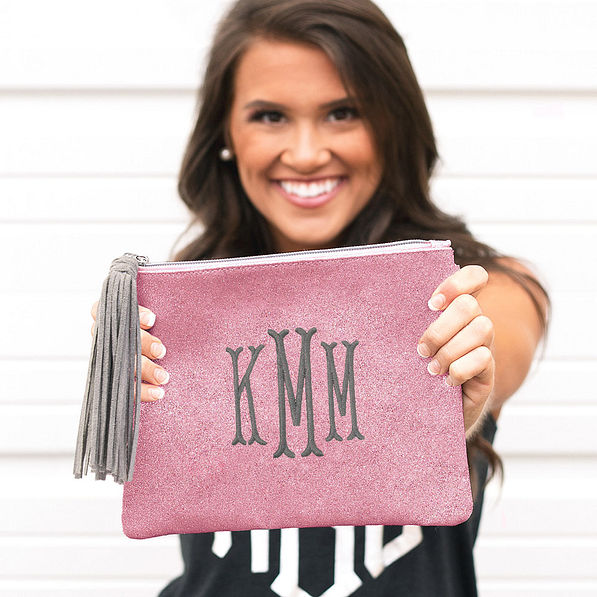 brunette holding rose gold glitter clutch