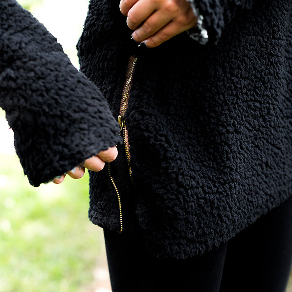 gold side zipper on black herpa turtleneck tunic