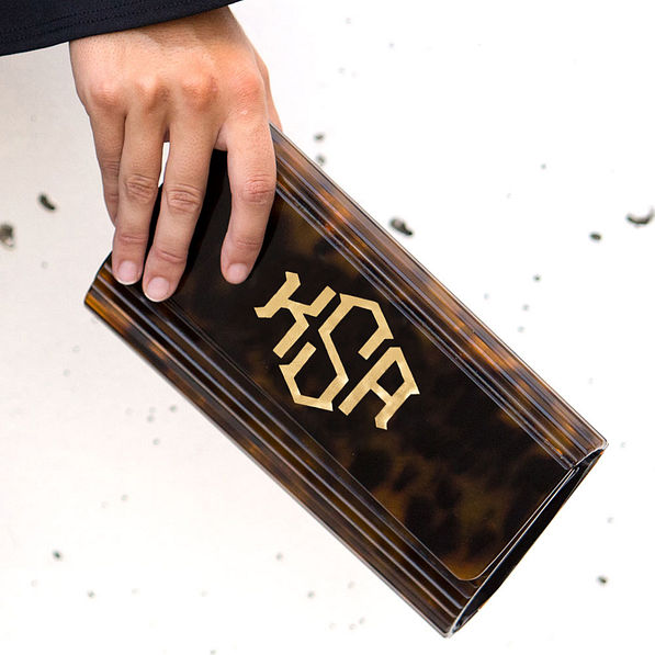 close up of monogrammed tortoise clutch