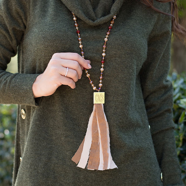 monogrammed beaded pendant tassel necklace in gold and brown with olive sweater