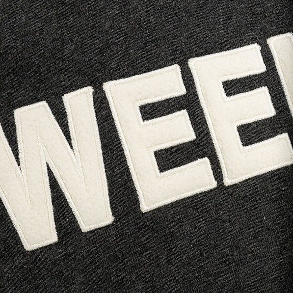 up close of letters on weekend pullover