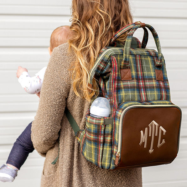 mom holding baby with plaid monogrammed diaper backpack