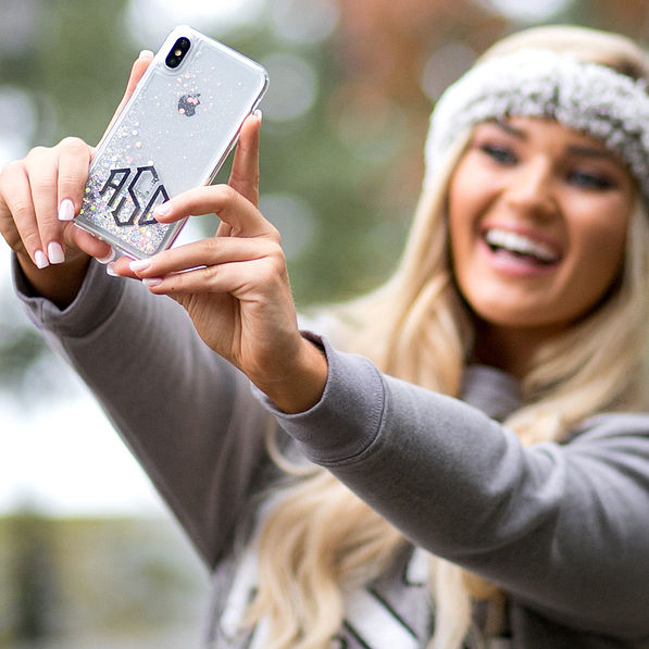 taking selfie with silver glitter phone case