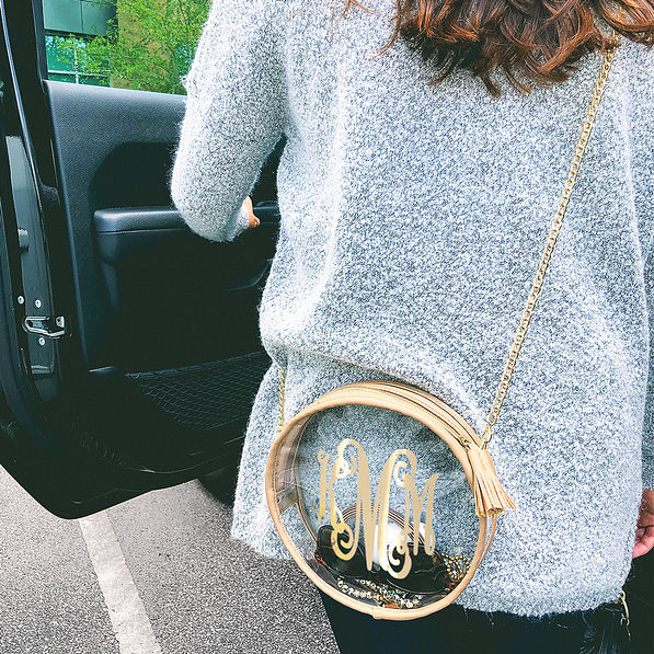 clear circle crossbody bag with boyfriend sweater on girl getting in car