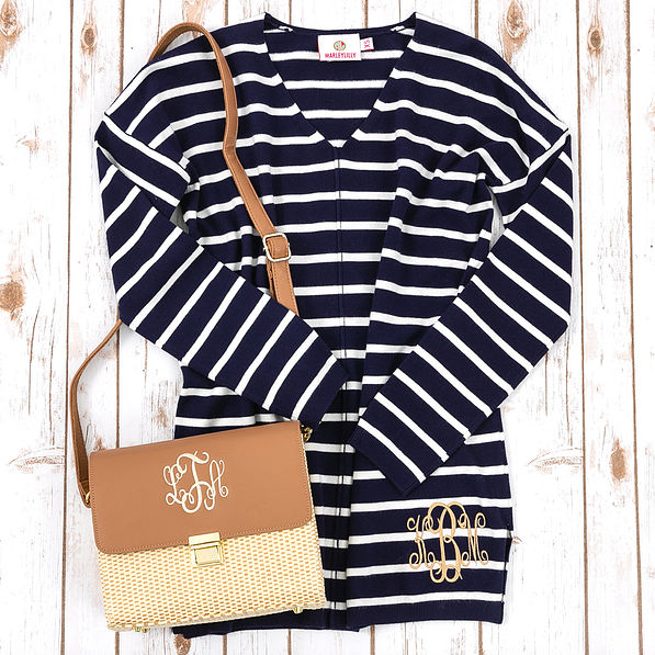 navy v-neck sweater with monogrammed straw crossbody