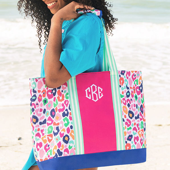 multi leopard monogrammed mega beach bag on girl's shoulder (NEW)