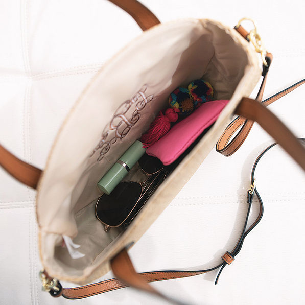 inside of round straw purse with crossbody strap