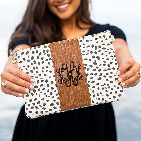close up of monogrammed spring leopard print clutch