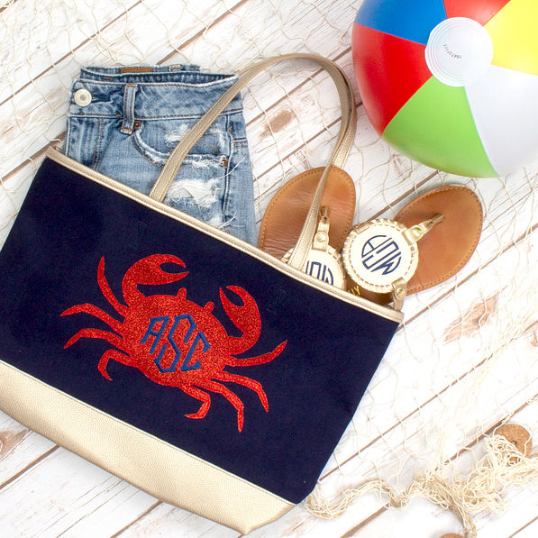 monogrammed crab beach bag with sandals and denim shorts