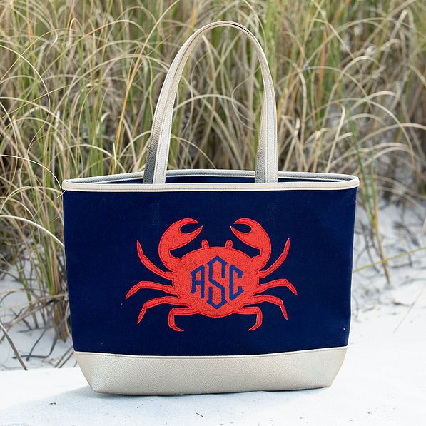 monogrammed crab beach tote sitting in the sand at the beach
