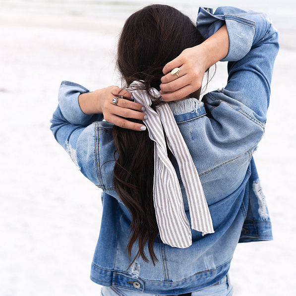 tying seersucker scrunchie with jean jacket