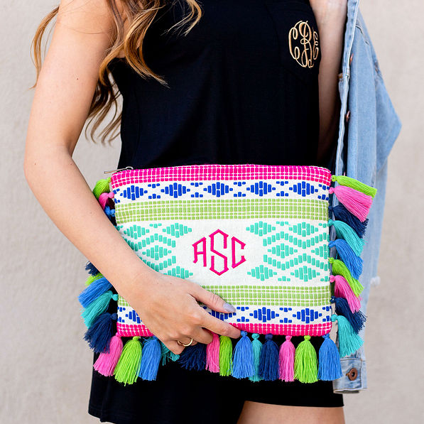 monogrammed tropical clutch with black romper and jean jacket