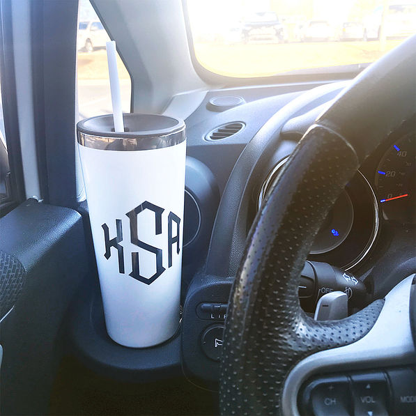 white monogrammed stainless steel cup in car