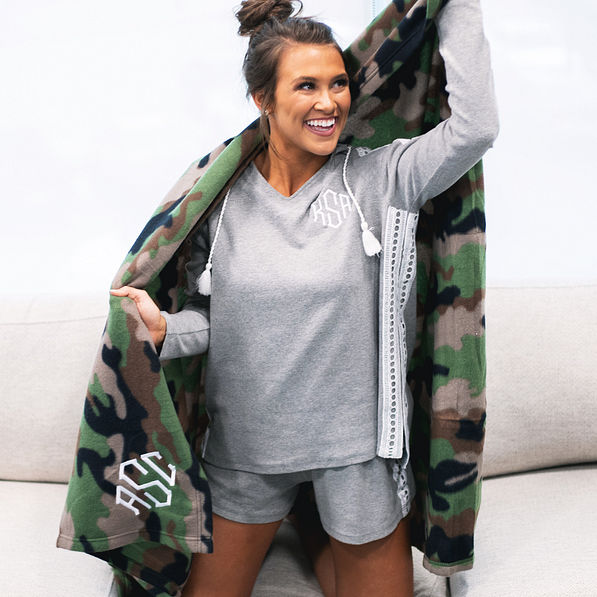 girl wrapped in soft camo blanket on the couch