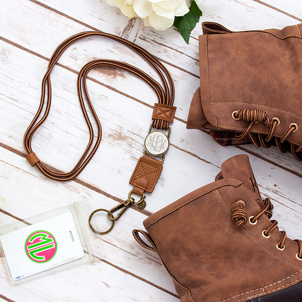 flat lay of duck boot lanyard with duck boots on white wood