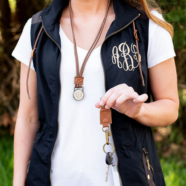 monogrammed black utility vest and separated duck boot lace lanyard outside
