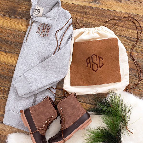 monogrammed cinch bag with duck boots and pullover sweatshirt
