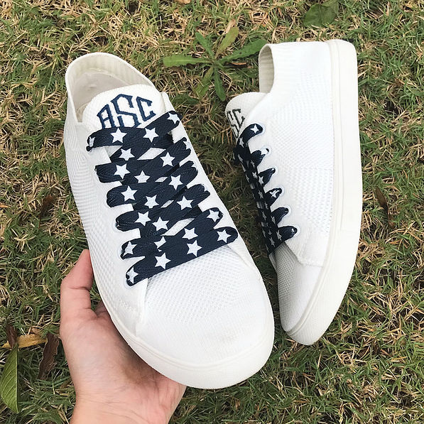 navy star shoe laces on monogrammed knit sneakers