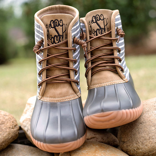 monogrammed gray duck boots on rocks