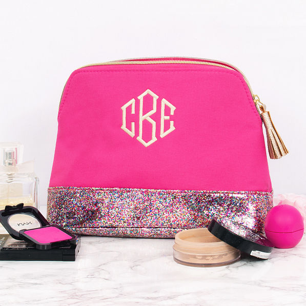 monogrammed glitter and hot pink cosmetic bag with makeup