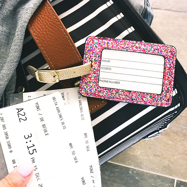 confetti luggage tag attached to suitcase at the airport
