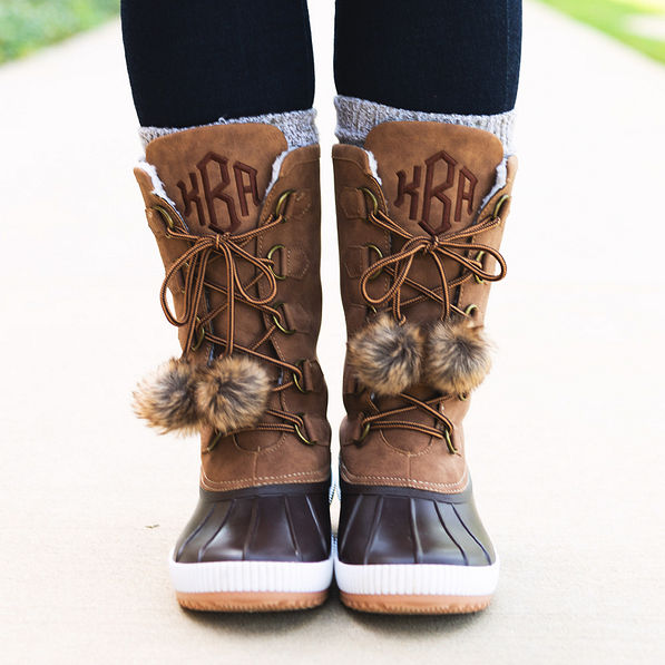 brown pom poms on winter duck boots