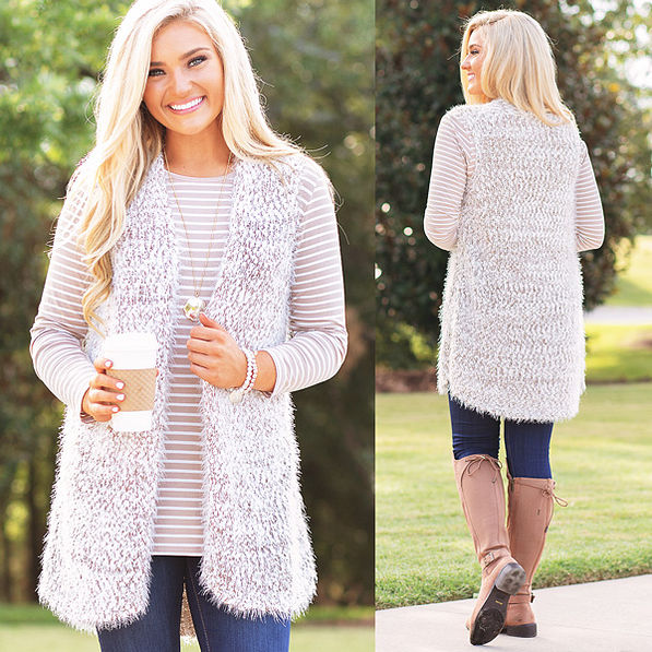 cozy knit vest on top of tan striped dropped hem layering tunic with riding boots