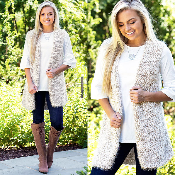 cozy knit vest with dropped hem layering tunic and monogrammed riding boots