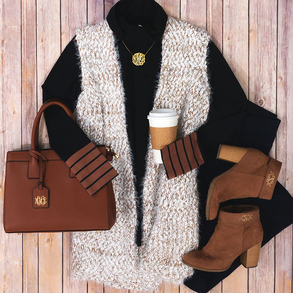 cozy knit vest with black turtleneck and monogrammed purse