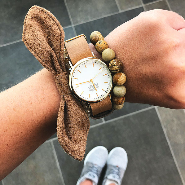 suede bow on wrist with monogrammed watch