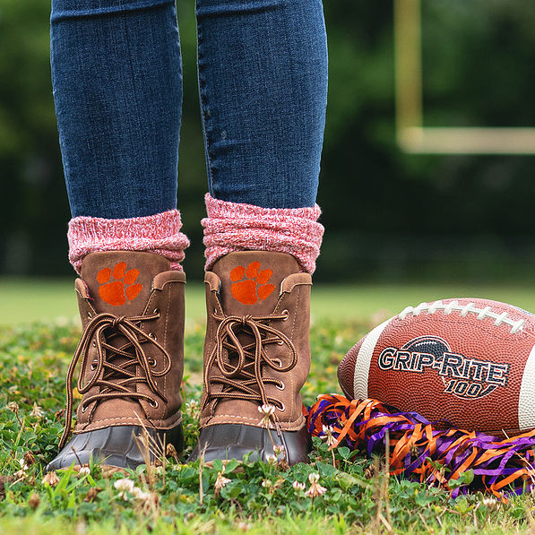 clemson duck boots and orange socks on football field