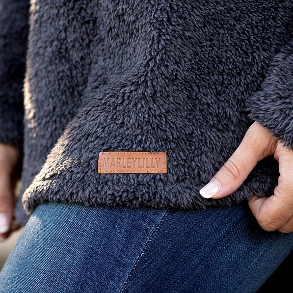 leather branding on sherpa pullover tunic
