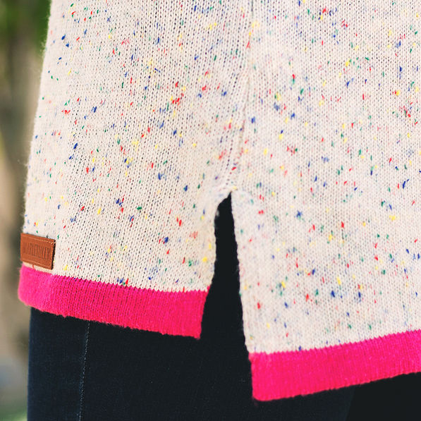close up view of confetti sweater with hot pink hem