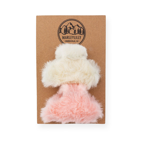 fuzzy white and pink hair clips on card