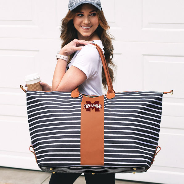 mississippi state striped weekender bag on shoulder