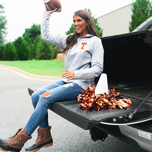 tennessee fan wearing pullover sweatshirt and throwing football