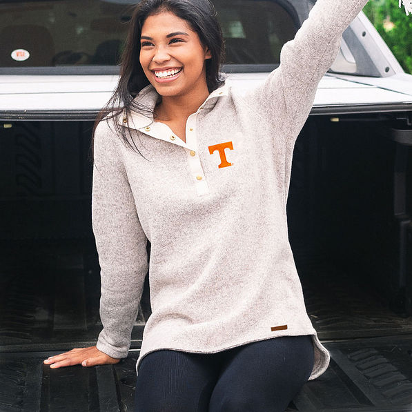 girl sitting on truck tailgate wearing tennessee heathered pullover